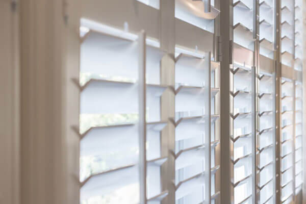 Blind Shack of Central FL | White shutters on a window in a room.