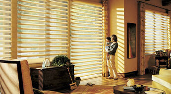 Blind Shack of Central FL | A woman standing in front of a window with blinds.